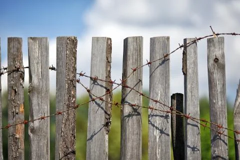 Fence with barbed wire Stock Photos