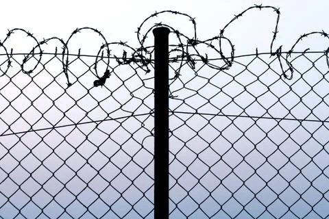 Fence with barbed wire Stock Photos
