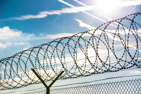 Fence with barbed wire Stock Photos