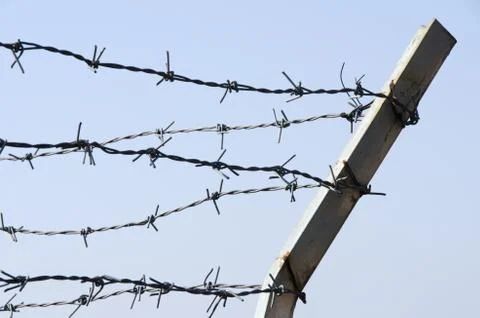 Fence with barbed wire Stock Photos