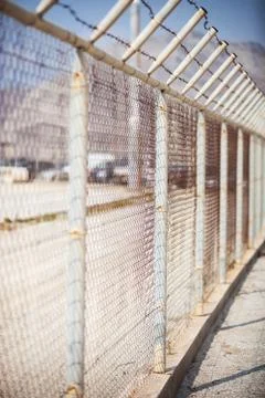 Fence with barbed wire Stock Photos