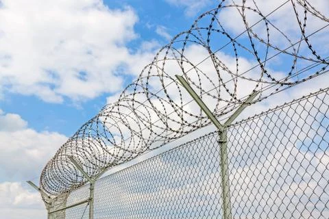 Fence with barbed wire Stock Photos