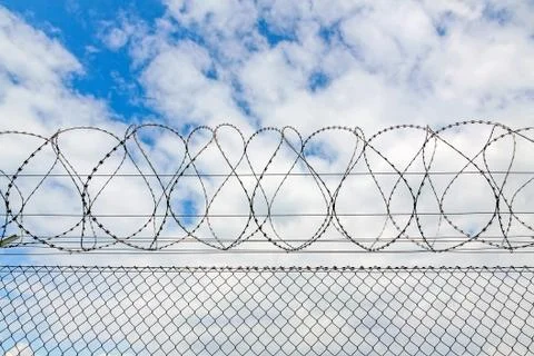 Fence with barbed wire Stock Photos