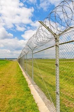 Fence with barbed wire Stock Photos