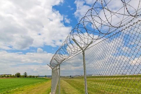 Fence with barbed wire Stock Photos