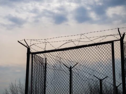 A fence with barbed wire Stock Photos
