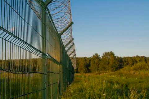Fence with barbed wire. Stock Photos