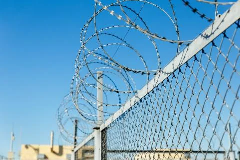 Fence with barbed wire Stock Photos