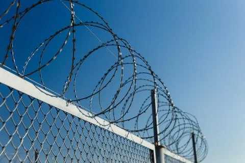 Fence with barbed wire Stock Photos