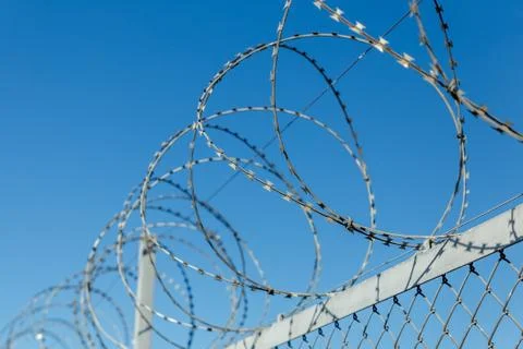 Fence with barbed wire Stock Photos