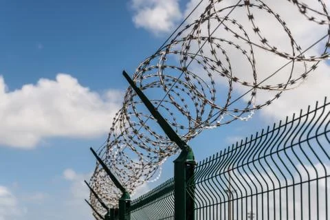 Fence with barbed wire Stock Photos