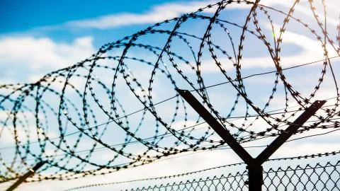 Fence with barbed wire Stock Photos