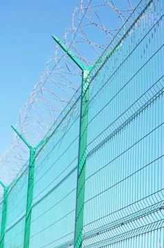 Fence with barbed wire Stock Photos