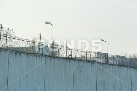 Fence with barbed wire, place of detention Stock Photos