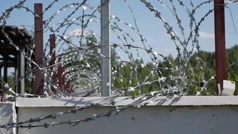 A fence with barbed wire. Security systems Restricted area or prison Stock Footage 142562033