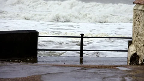 A fence is on the beach next to the ocean Stock Footage 298264959