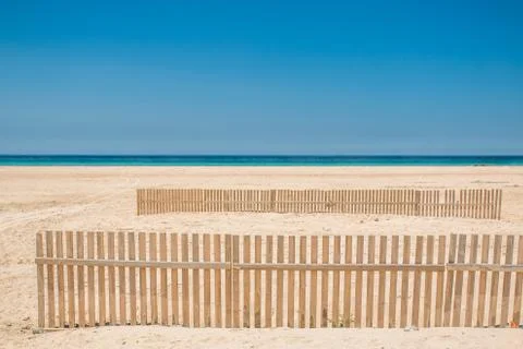 Fence on a beach Stock Photos