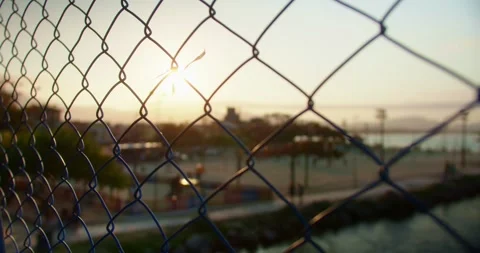 Fence of a Bridge in the Sunset at the Beach Stockbeeldmateriaal 247460725
