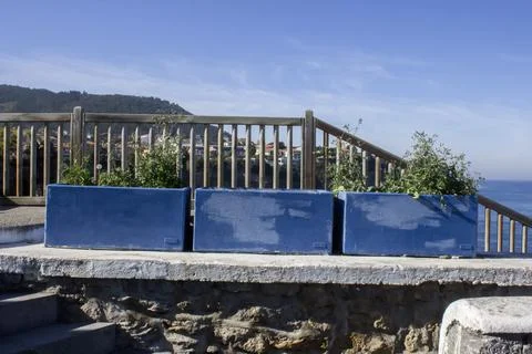 A fence on a cliff by the ocean. Stock Photos
