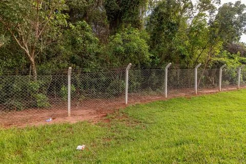 Fence with concrete posts and wire mesh Stock Photos