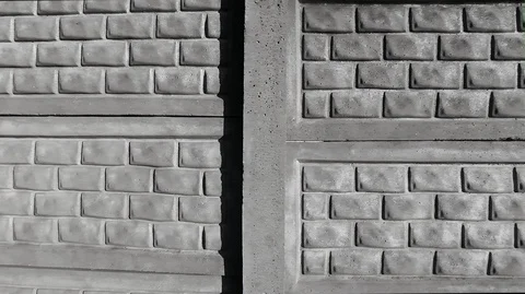 Fence of concrete sections made in the form of bricks in white Stock Footage 124922245