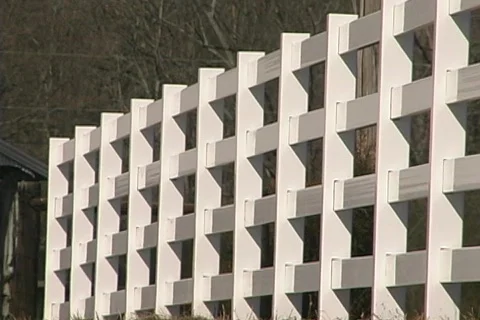 Fence with construction worker walking Stock Footage 436634