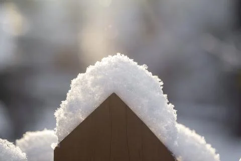 Fence covered with snow in the sunlight Stock Photos