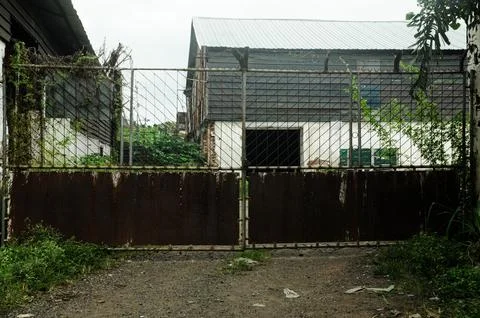 The fence of an empty house is damaged and not maintained Foto stock