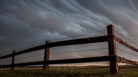 Fence in the field under stormy cloud sky. Stock Footage 64488264