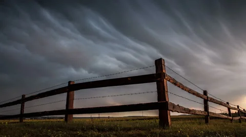 Fence in the field under stormy cloud sky. Stock Footage 65221847