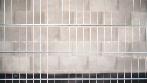 Fence in front of a concrete wall Stock Footage 120955023