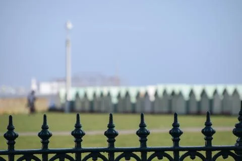 A fence in front of a row of beach huts Stock Photos