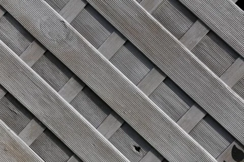 Fence from gray plastic material imitating wood Stock Photos