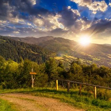 Fence on hillside in mountain at sunset Foto stock
