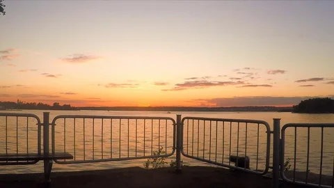 Fence on the lake at sunset in summer 스톡 동영상 82371349