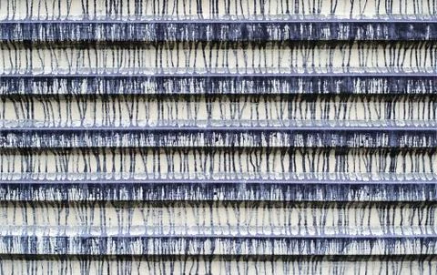 The fence is made of corrugated tin with multiple stains of paint. Texture. G Stock Photos