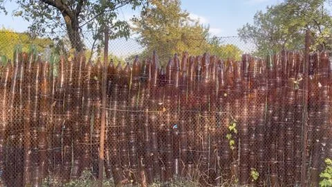 Fence made of plastic bottles Stock Photos