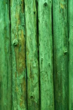 The fence is made of round vertical pine logs, rich green color. Background Stock Photos