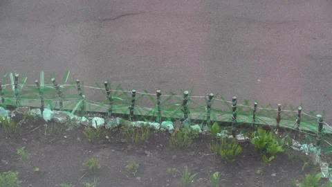 Fence made of sticks and cut bottles Stock Footage 153781282