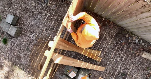 Fence Maker Lines Up a Wood Picket Board Slat to Attach to Backer Board Ove.. Video stock 235572821
