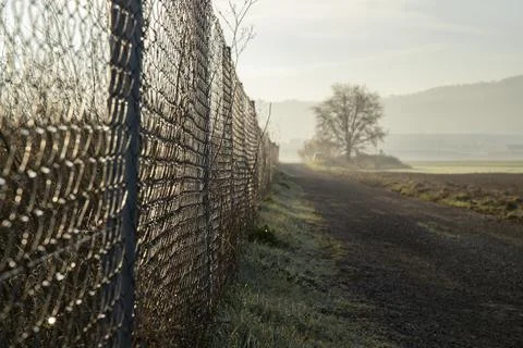 Fence next to a path Stock Photos