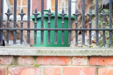 Fence over brick wall Stock Photos