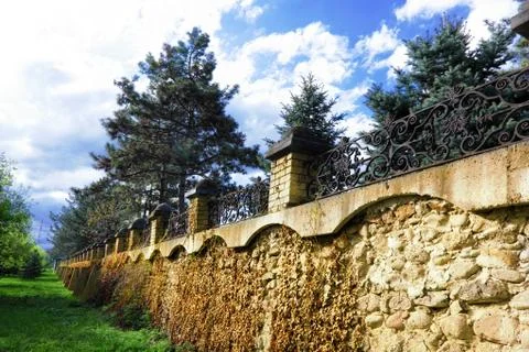 Fence placed a long brick wall. Stock Photos