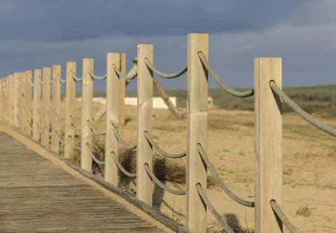 Fence posts in a row going off into the distance Stock Photos