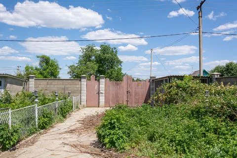 Fence of a private house. View from the yard on fence with patterned iron gat Stock Photos