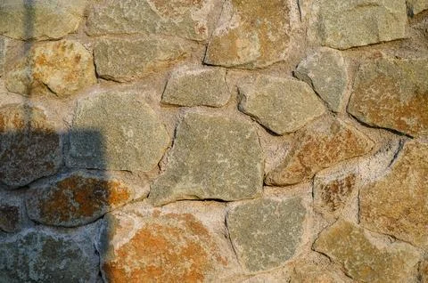 Fence real stone wall surface with cement as background. 写真素材