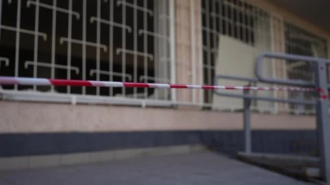 Fence of red and white warning tape at the old ruined building.  Stock Footage 305753456