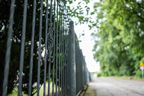 Fence running next to plot along road in suburban Фото