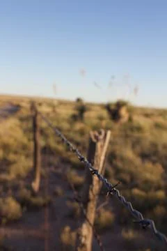 Fence Running through Desert Stock Photos