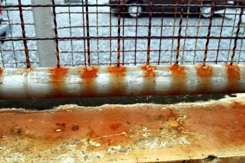 The fence that is rusty in brown because of the sun and rain for a long time Stock Photos